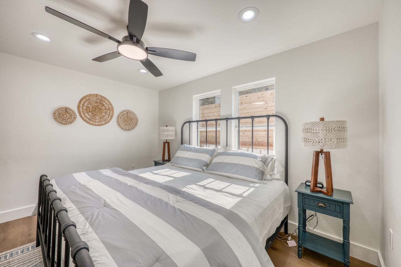 569 Ellen Williams Loop Kingsland, TX 78639 - Photo 25 of 29 a bedroom with a bed and a chandelier