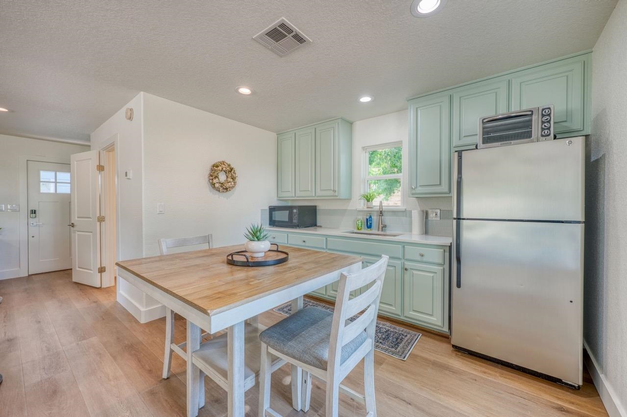 569 Ellen Williams Loop Kingsland, TX 78639 - Photo 26 of 29 a kitchen with refrigerator and wooden floor