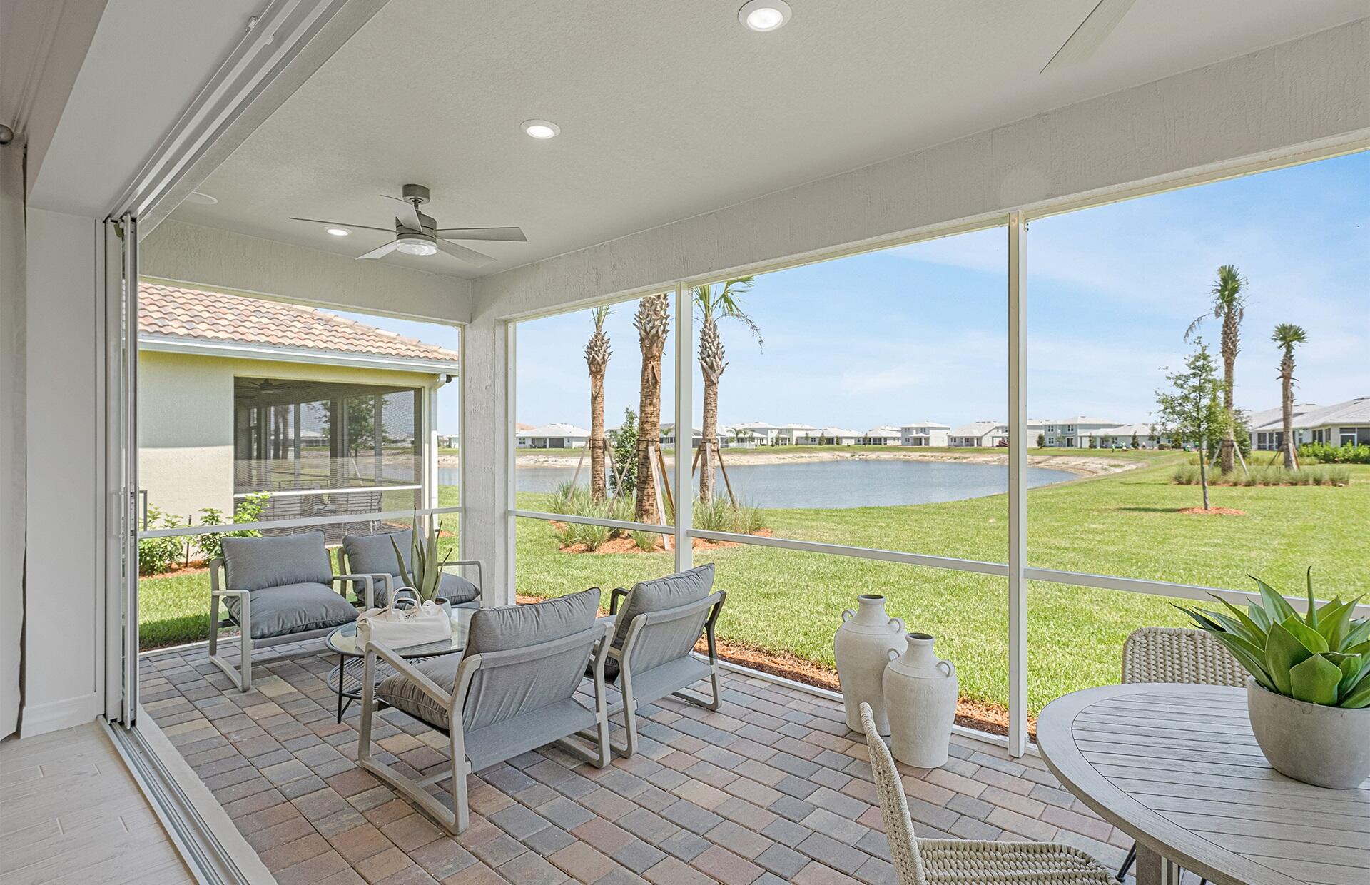 10461 Southwest Highpointe Drive, Unit WHITESTONE 258 Stuart, FL 34997 - Photo 14 of 32 a living room with furniture and floor to ceiling windows