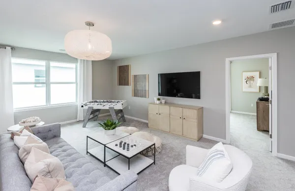 a bedroom with a bed and a dresser next to a window