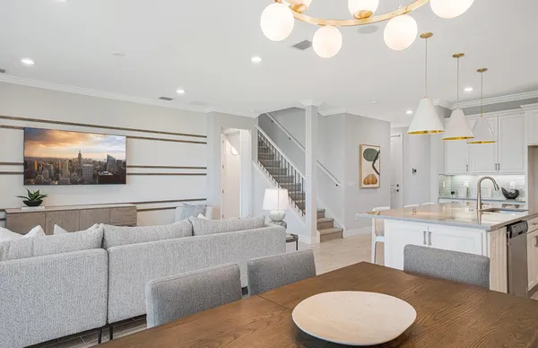 a kitchen with stainless steel appliances a table and chairs