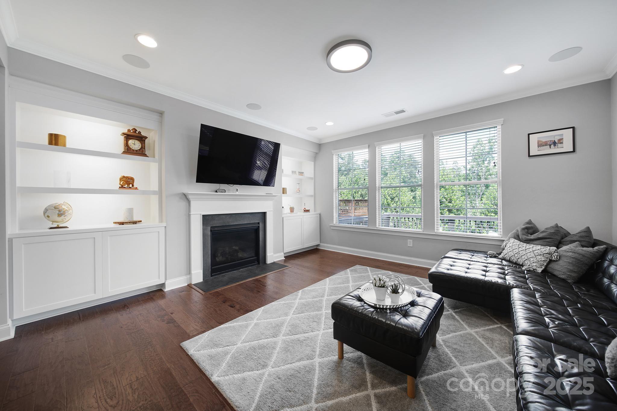 1001 Emory Lane Fort Mill, SC 29708 - Photo 11 of 45 a living room with furniture a flat screen tv and a fireplace