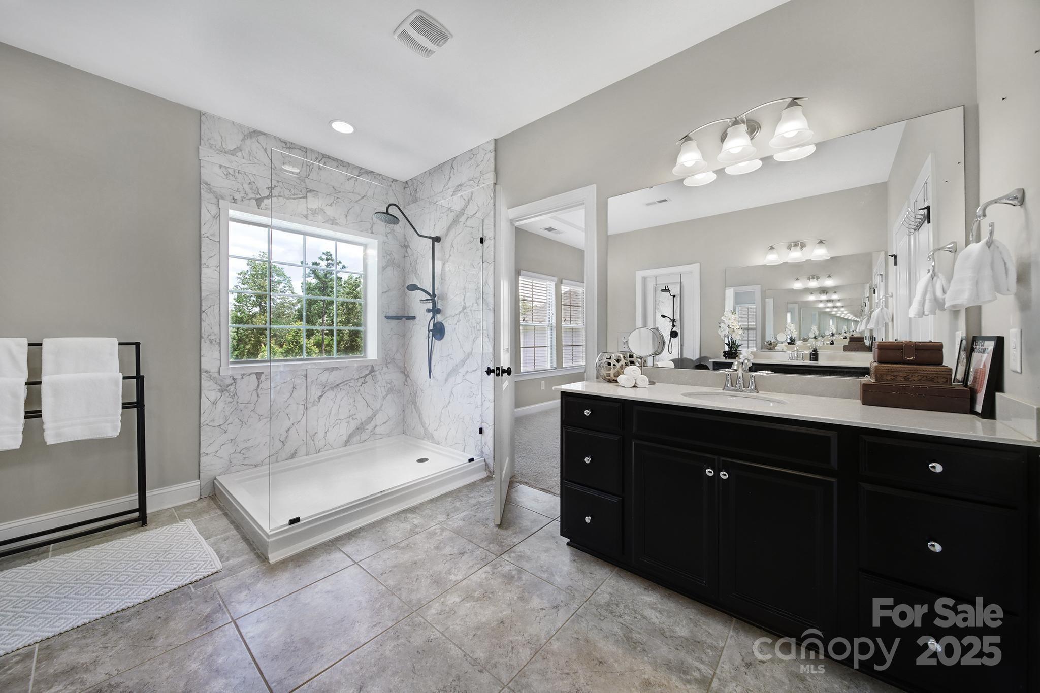 1001 Emory Lane Fort Mill, SC 29708 - Photo 24 of 45 a spacious bathroom with a tub shower and mirror