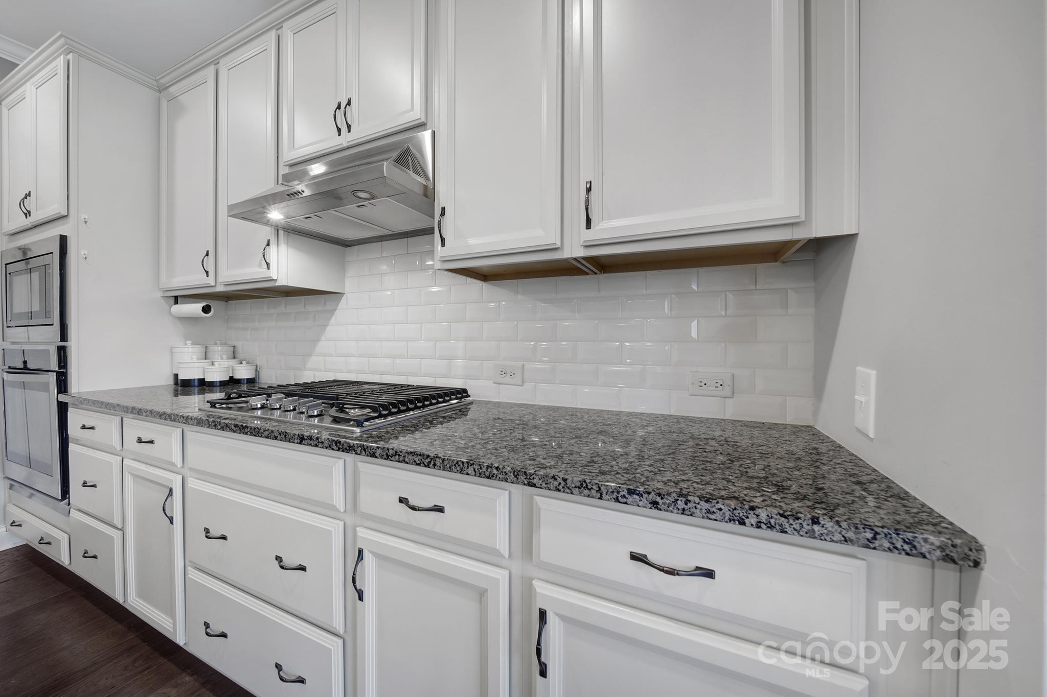 1001 Emory Lane Fort Mill, SC 29708 - Photo 6 of 45 a kitchen with white cabinets and a stove