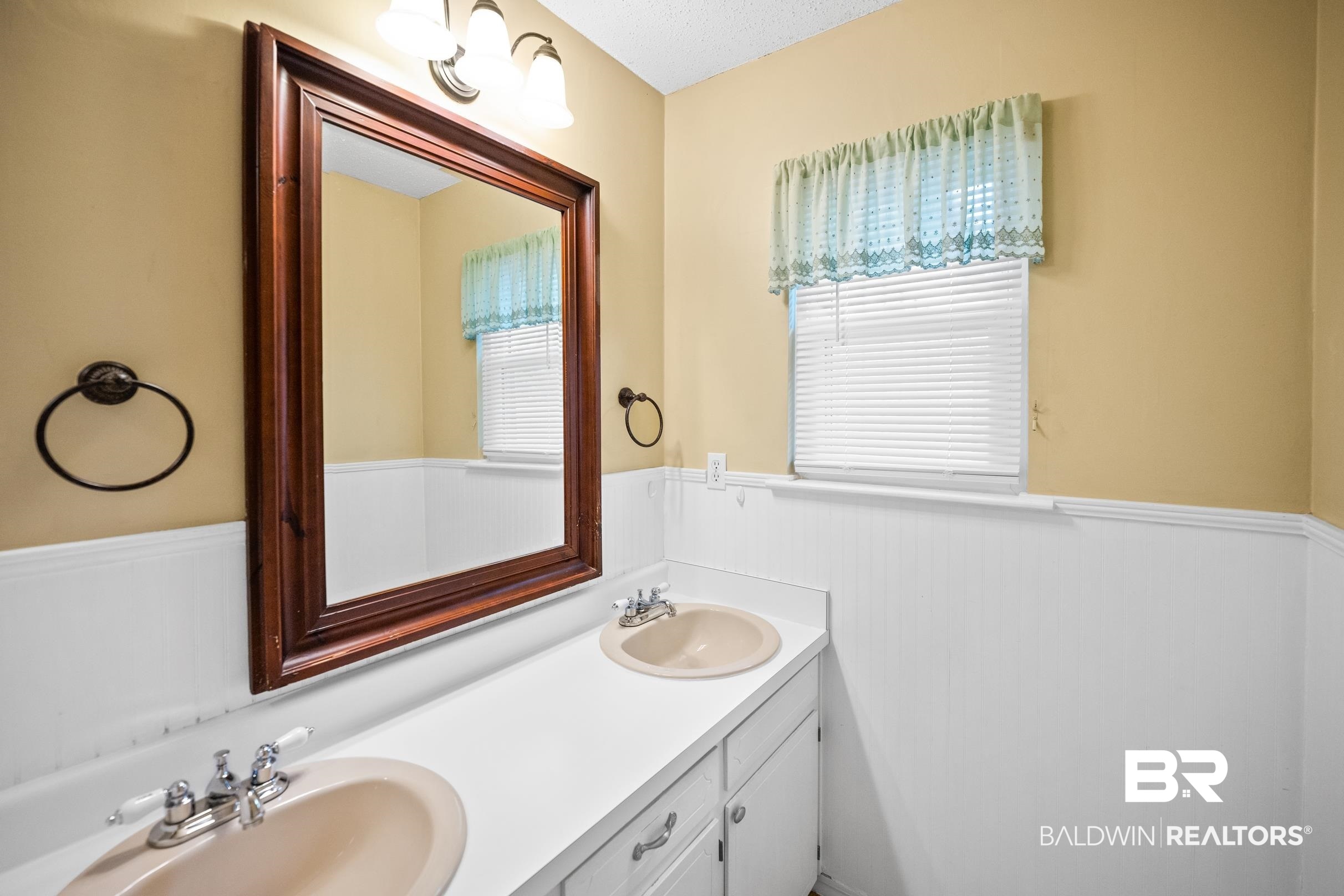 123 Dunbar Loop Daphne, AL 36526 - Photo 18 of 33 Bathroom featuring a wainscoted wall, double vanity, and a decorative wall