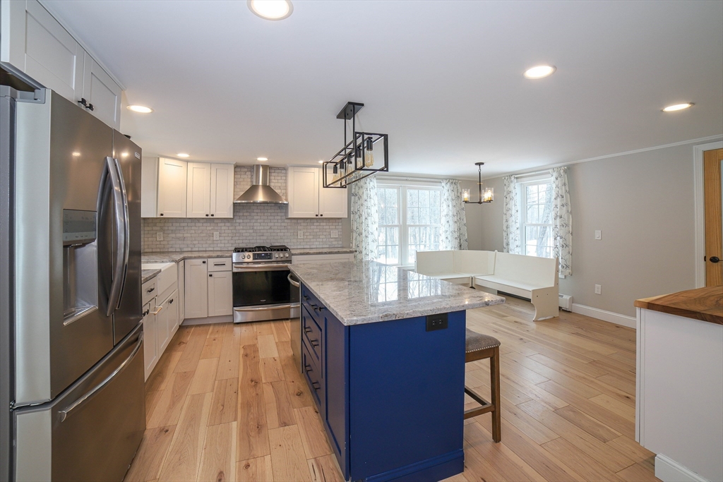 3 Woods Road Westminster, MA 01473 - Photo 5 of 42 a kitchen with granite countertop a refrigerator a sink dishwasher a stove and white cabinets with wooden floor