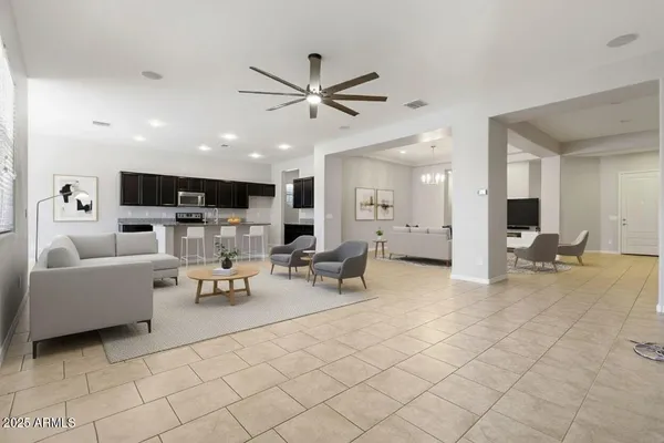 a living room with furniture and view of kitchen