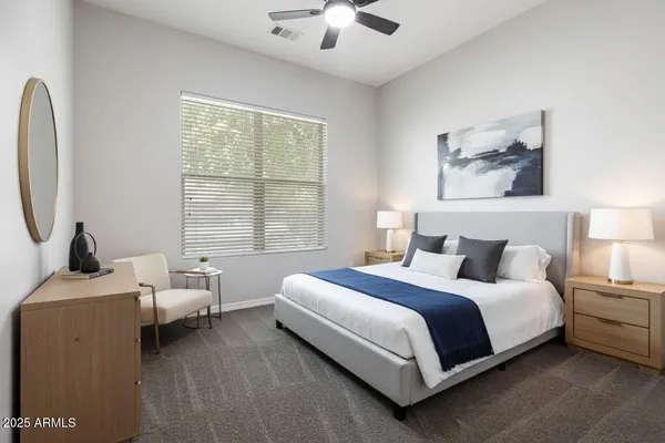 a bedroom with a bed and a large window