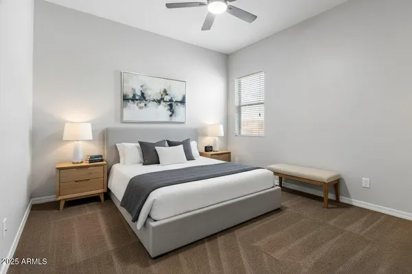 a bedroom with bed and a chandelier