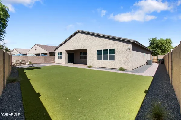 a view of a house with pool and chairs