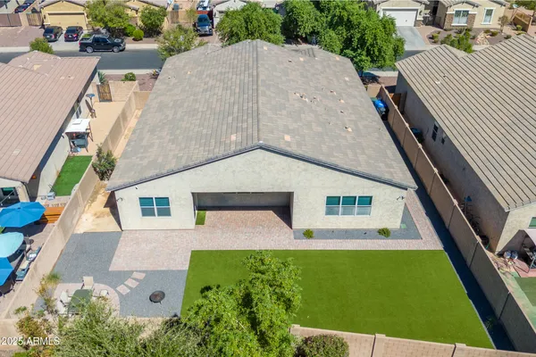an aerial view of a house with a yard
