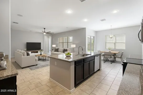 a kitchen with counter top space and living room