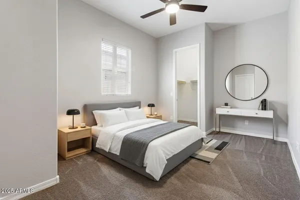 a bedroom with a bed a mirror and a window