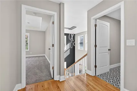 a view of a hallway view with wooden floor and staircase