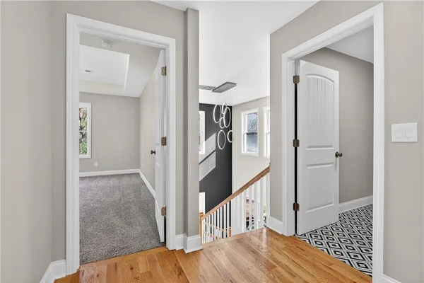 a view of a hallway view with wooden floor and staircase