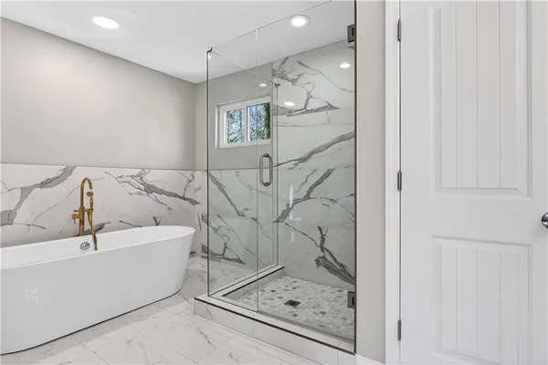 a bathroom with a bathtub and shower