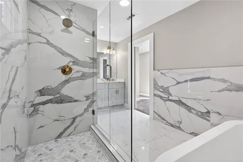 a bathroom with a tub and a shower