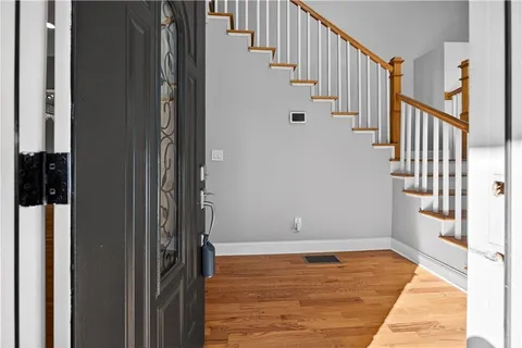 a view of entryway and hall with wooden floor