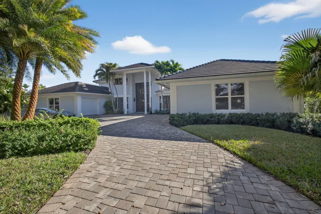 a dining room with wooden floor a chandelier a wooden table and chairs