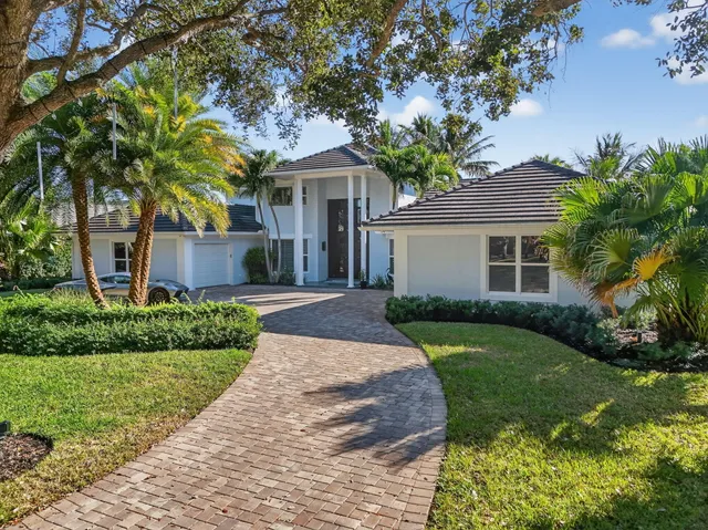 a bedroom with a bed and a flat tv screen on dresser