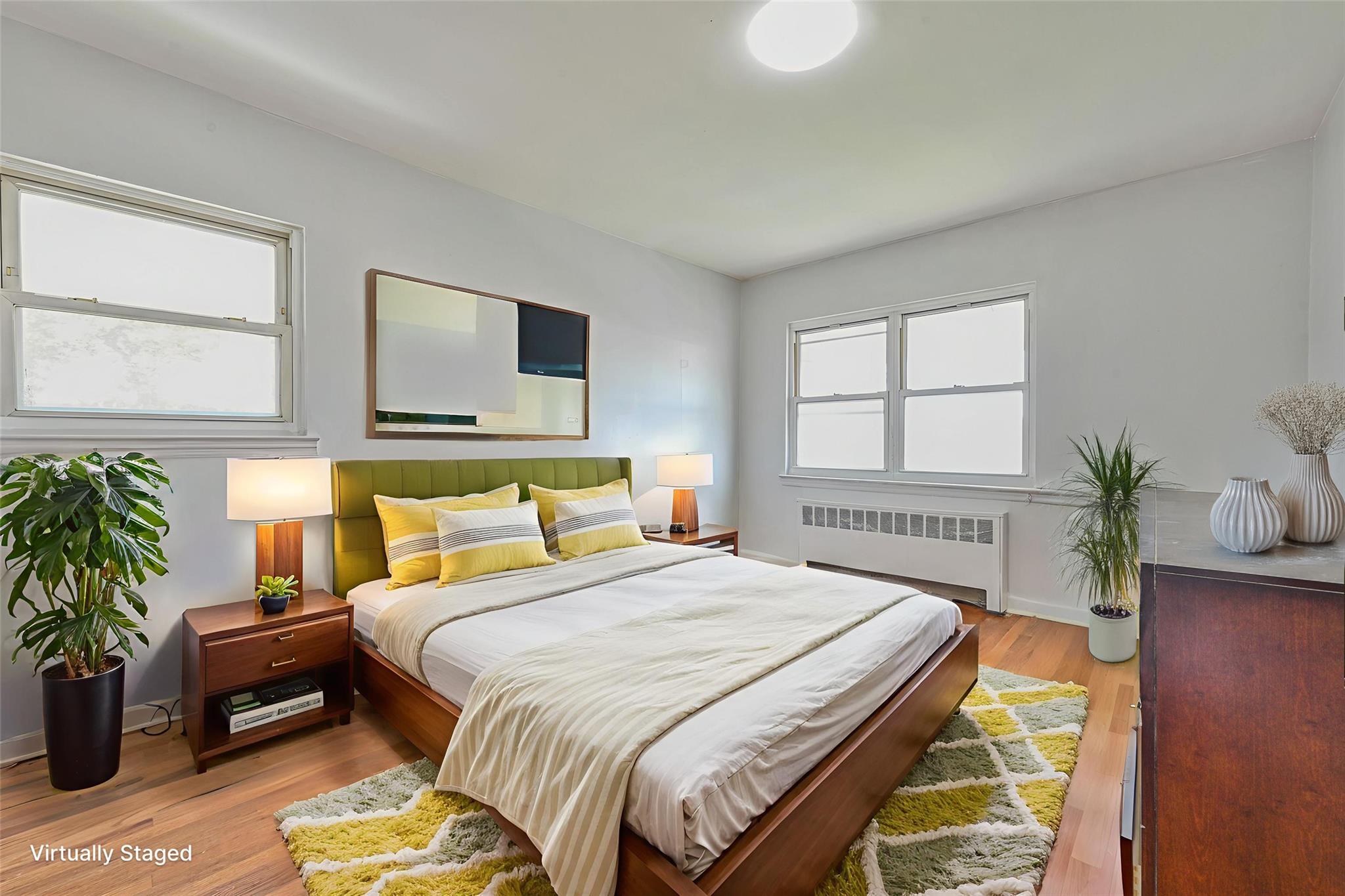 150-01 Horace Harding Expressway Queens, NY 11367 - Photo 9 of 17 Bedroom with radiator and light wood finished floors