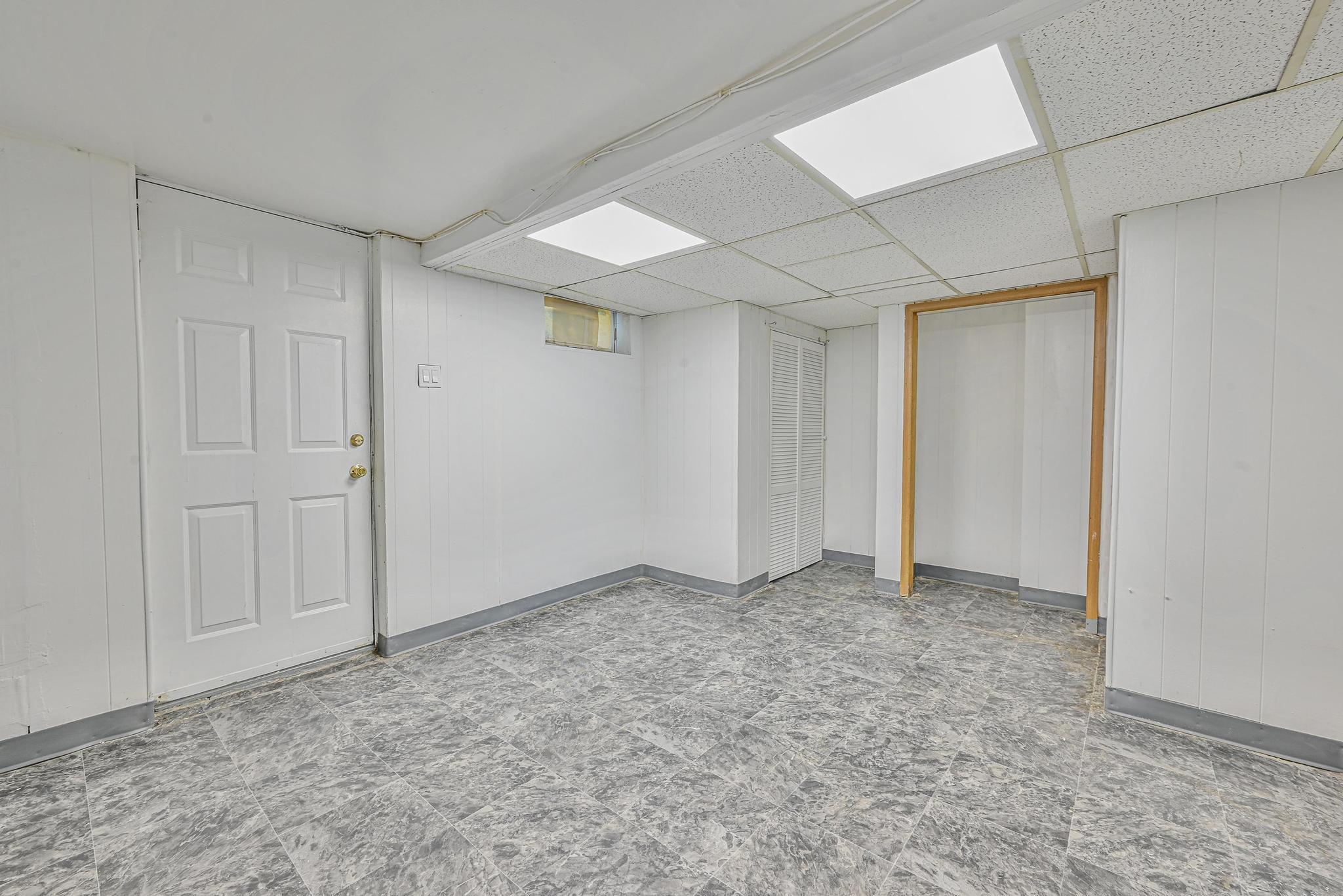 150-01 Horace Harding Expressway Queens, NY 11367 - Photo 10 of 17 Finished below grade area with a paneled ceiling and tile patterned floors