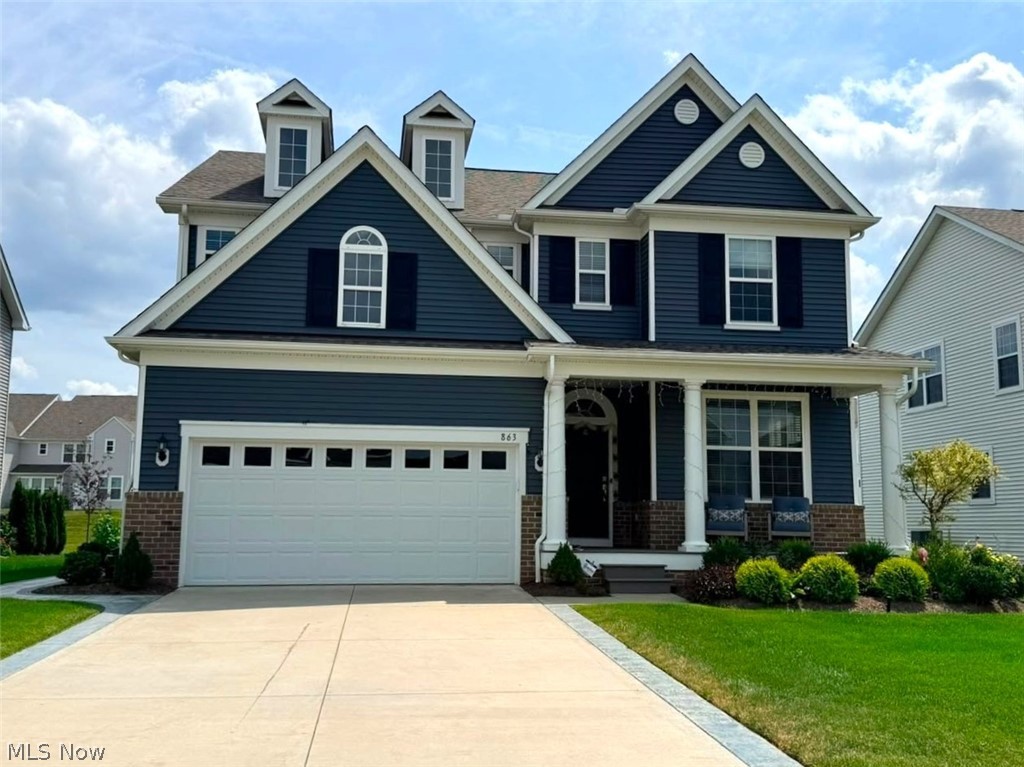863 River Run Road Aurora, OH 44202 - Photo 1 of 47 Two-story exterior with navy siding, white trim, and a covered front porch featuring white columns
