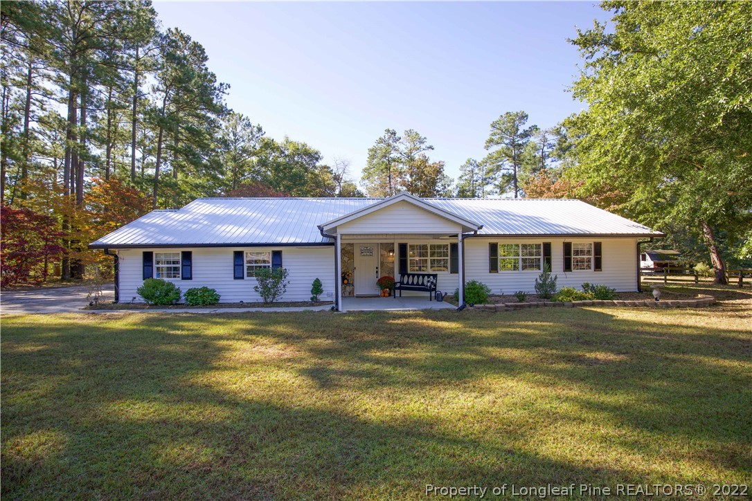 321 Pinecrest Court Road Aberdeen, NC 28315 - Photo 1 of 50 a front view of a house with a garden