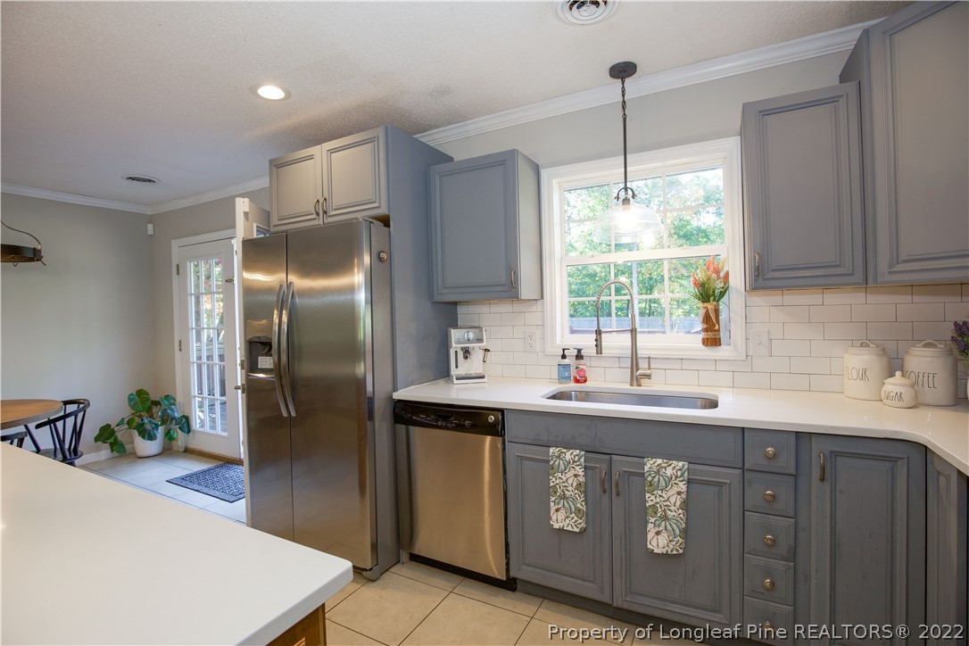 321 Pinecrest Court Road Aberdeen, NC 28315 - Photo 12 of 50 a kitchen with stainless steel appliances granite countertop a sink a refrigerator and a window
