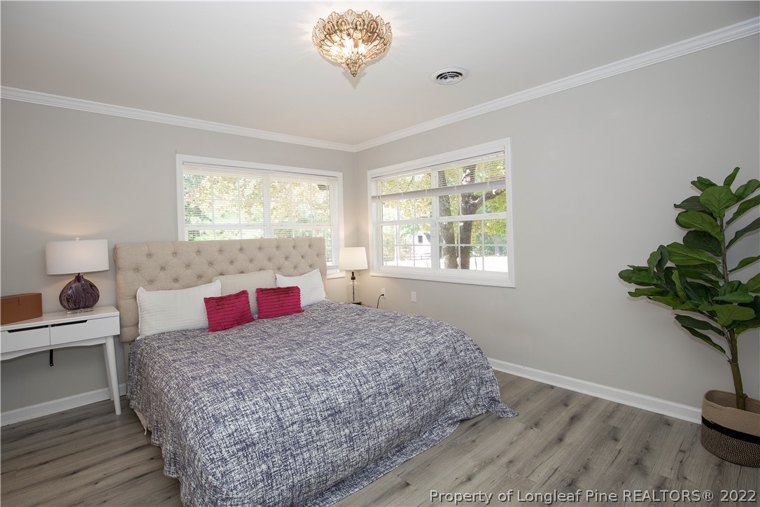 321 Pinecrest Court Road Aberdeen, NC 28315 - Photo 22 of 50 a bedroom with a bed and a potted plant