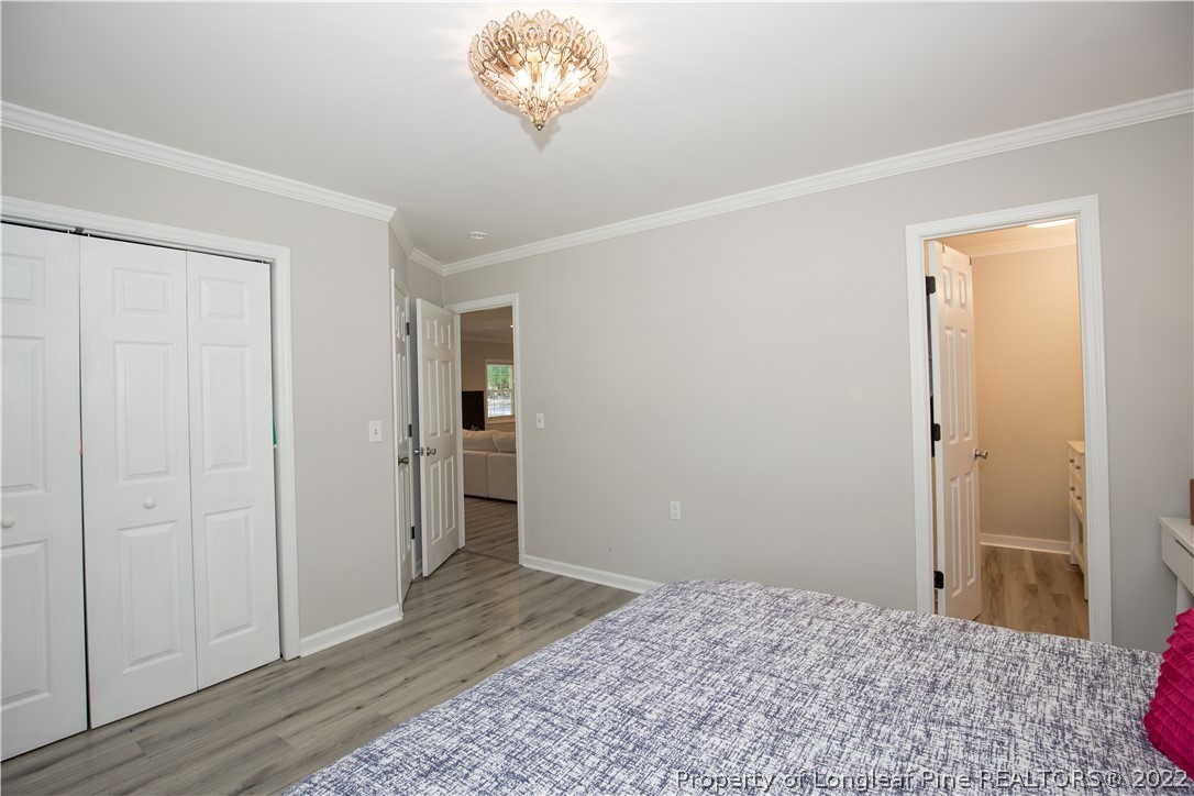 321 Pinecrest Court Road Aberdeen, NC 28315 - Photo 25 of 50 a view of a room with a chandelier fan and wooden floor