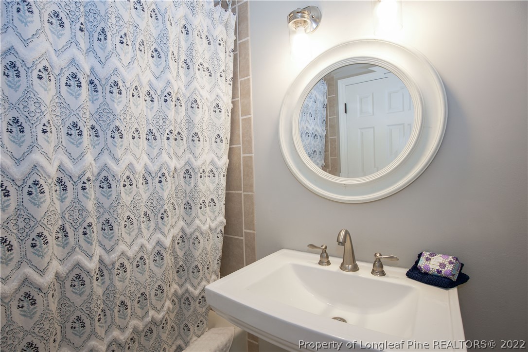 321 Pinecrest Court Road Aberdeen, NC 28315 - Photo 27 of 50 a bathroom with a sink and a mirror