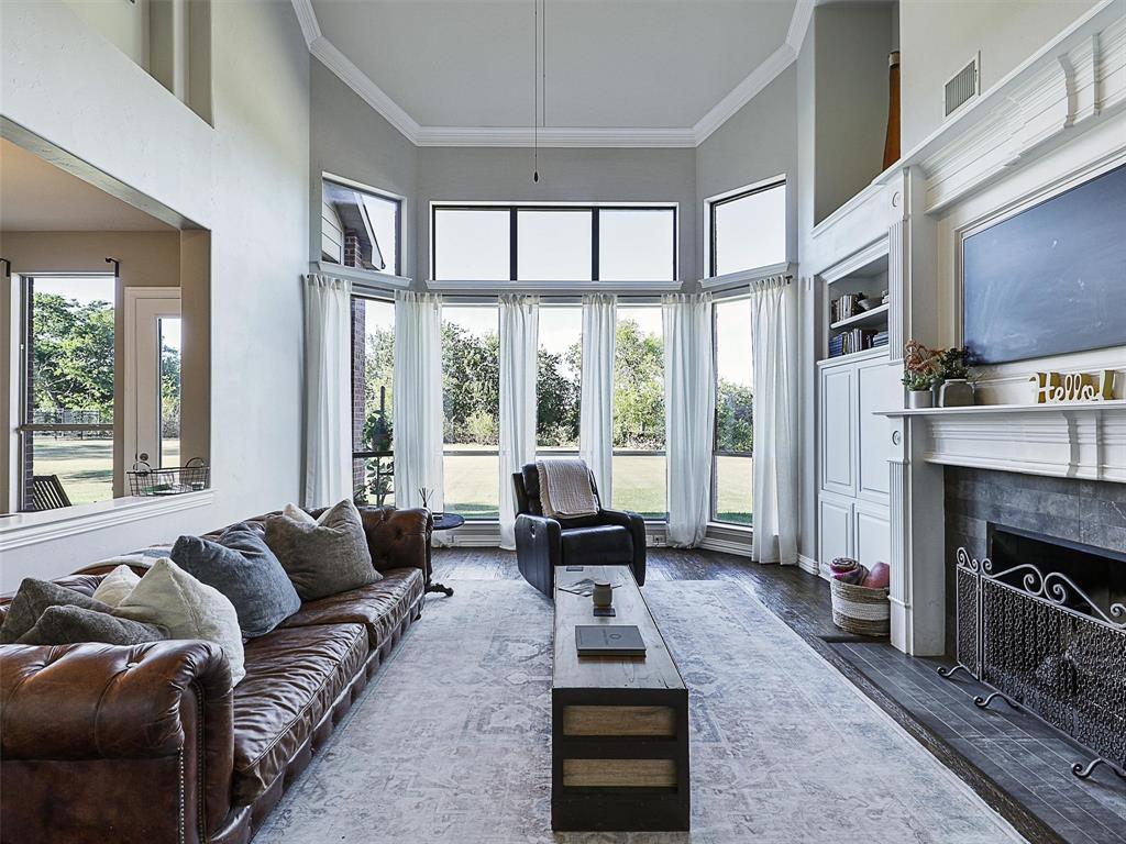 671 Countryside Drive Fairview, TX 75069 - Photo 11 of 32 a living room with furniture large window and a fireplace
