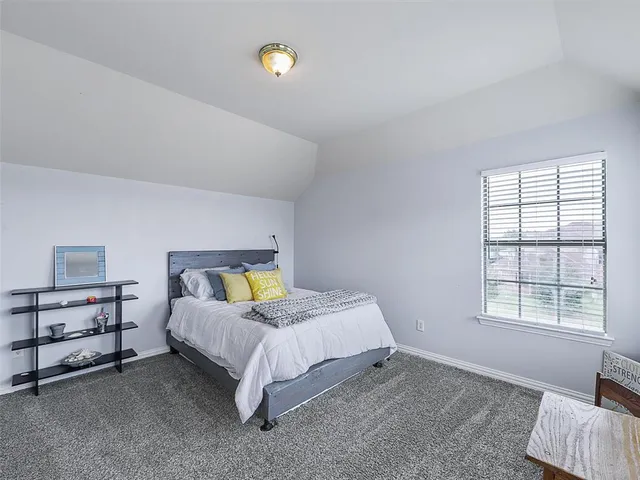 a bed room with a bed and a window