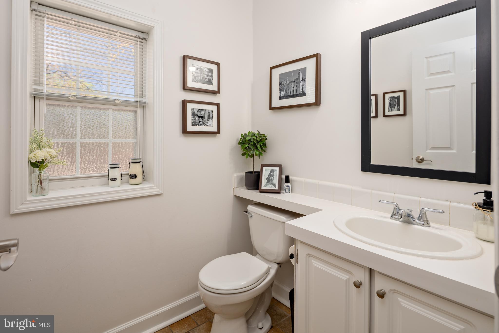 7213 Waterloo Pass Elkridge, MD 21075 - Photo 11 of 60 a bathroom with a toilet sink and mirror