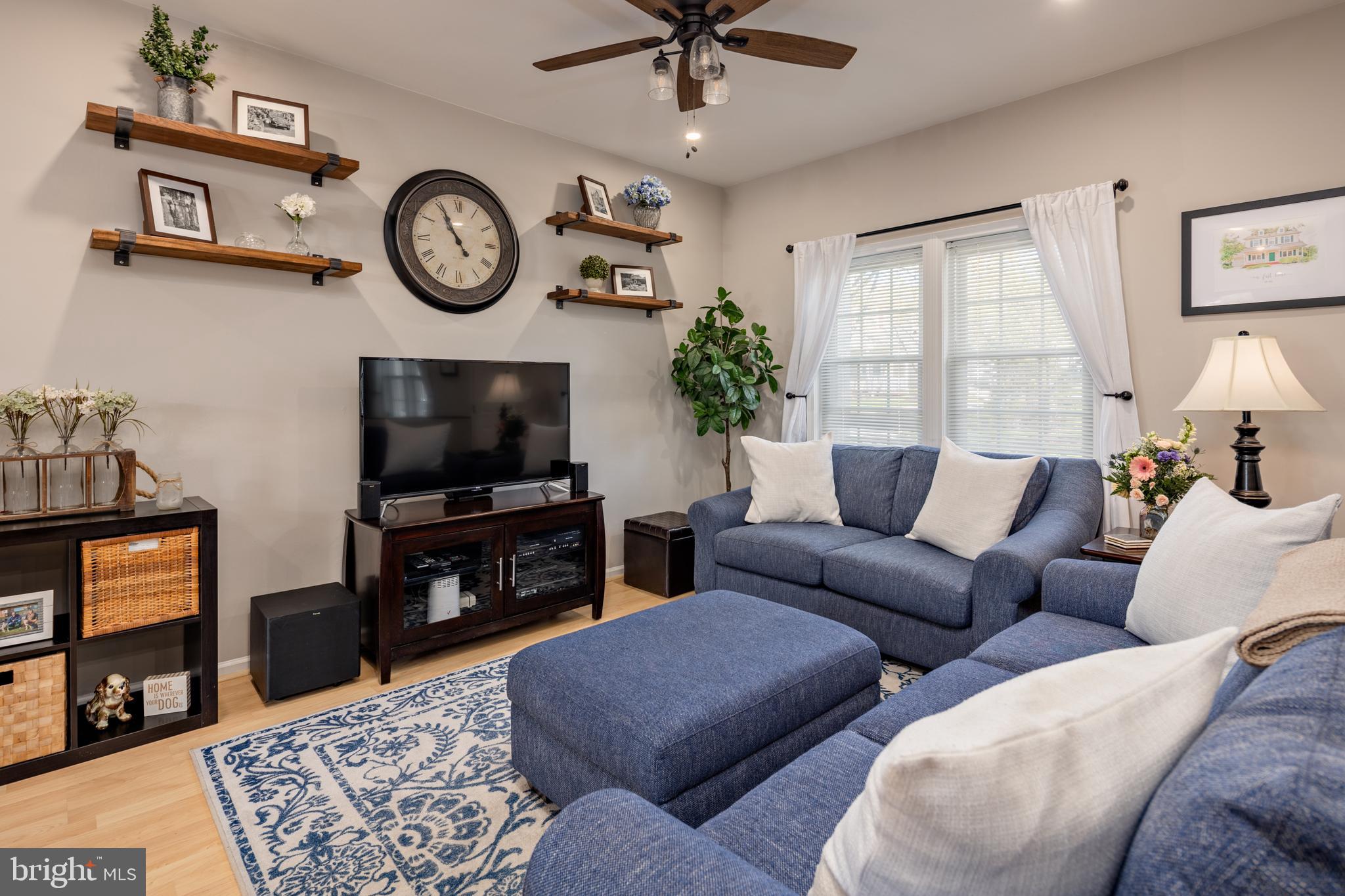 7213 Waterloo Pass Elkridge, MD 21075 - Photo 12 of 60 a living room with furniture a flat screen tv and a fireplace