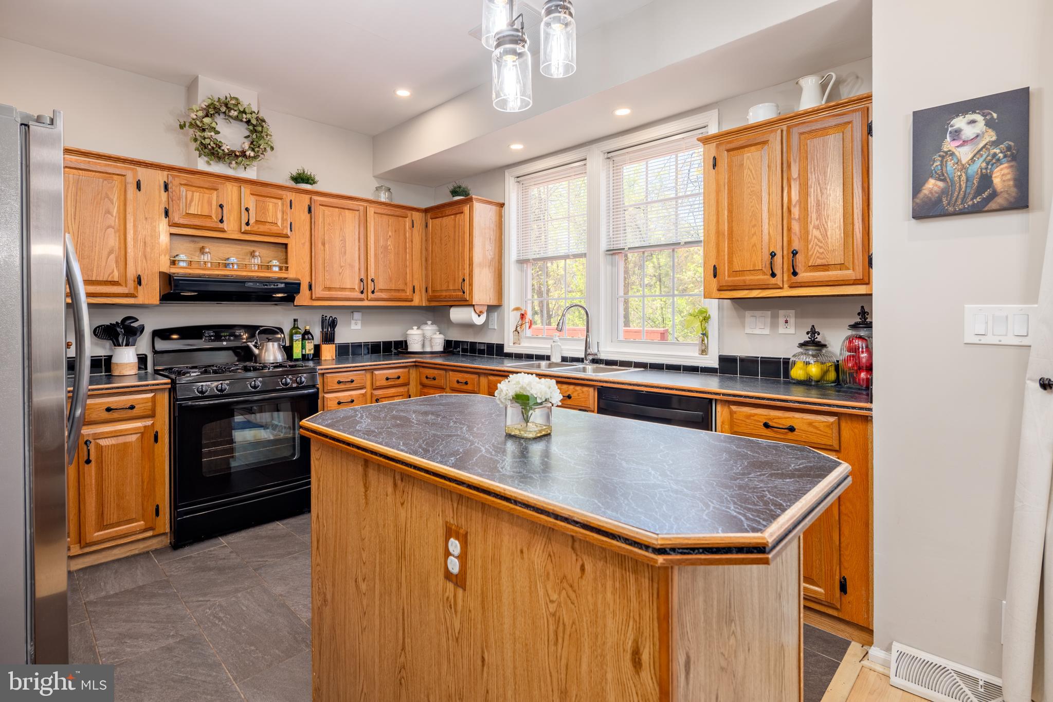 7213 Waterloo Pass Elkridge, MD 21075 - Photo 17 of 60 a kitchen with stainless steel appliances granite countertop a sink a stove and a refrigerator