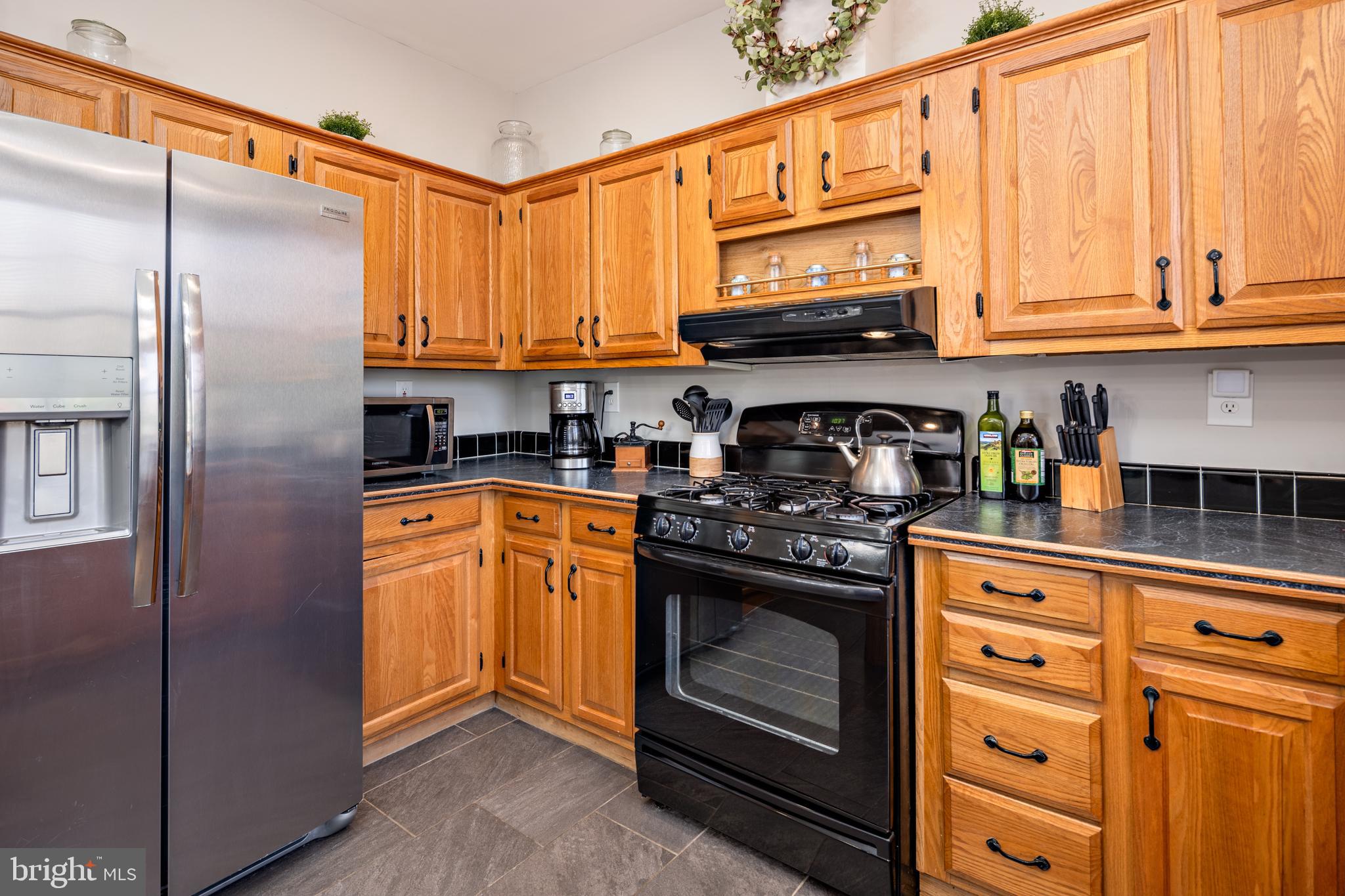 7213 Waterloo Pass Elkridge, MD 21075 - Photo 18 of 60 a kitchen with stainless steel appliances granite countertop a stove a sink and a refrigerator