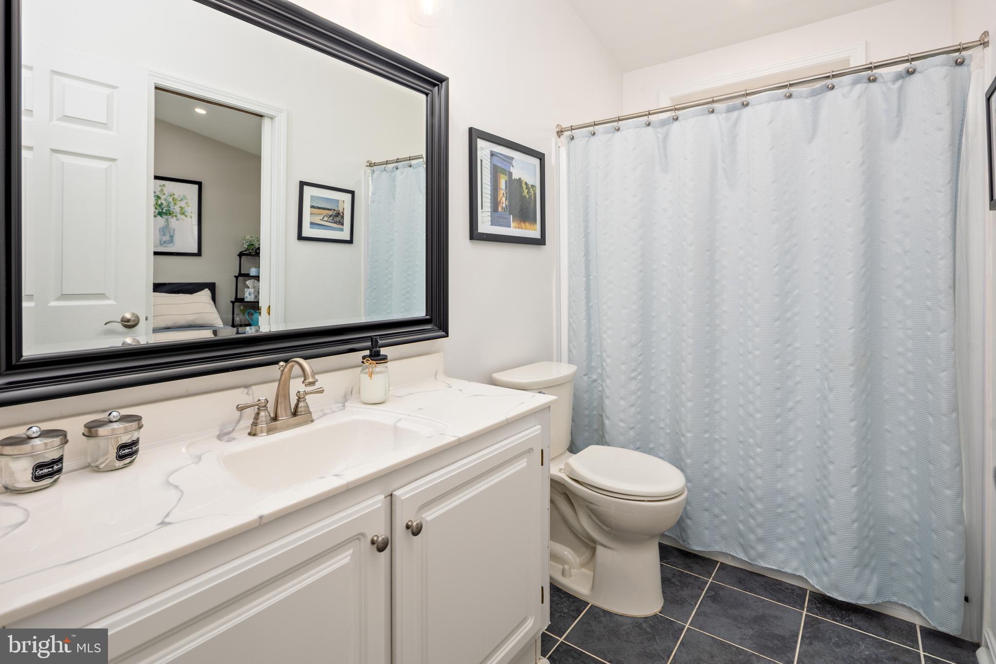 7213 Waterloo Pass Elkridge, MD 21075 - Photo 25 of 60 a bathroom with a sink toilet and mirror