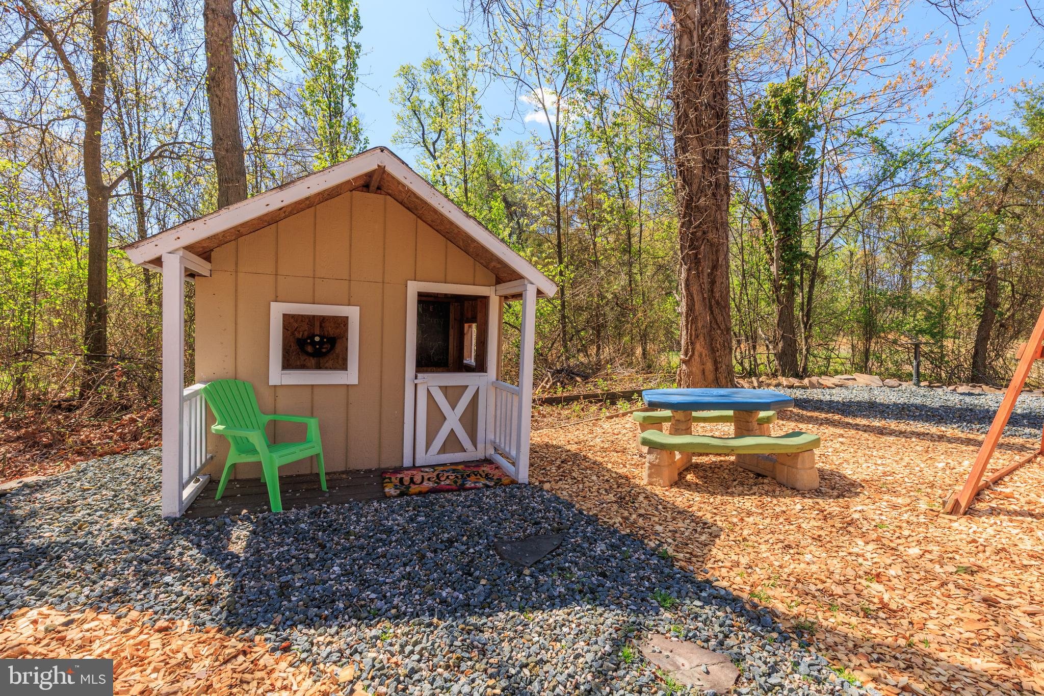 7213 Waterloo Pass Elkridge, MD 21075 - Photo 43 of 60 a view of a small house with a yard and sitting area