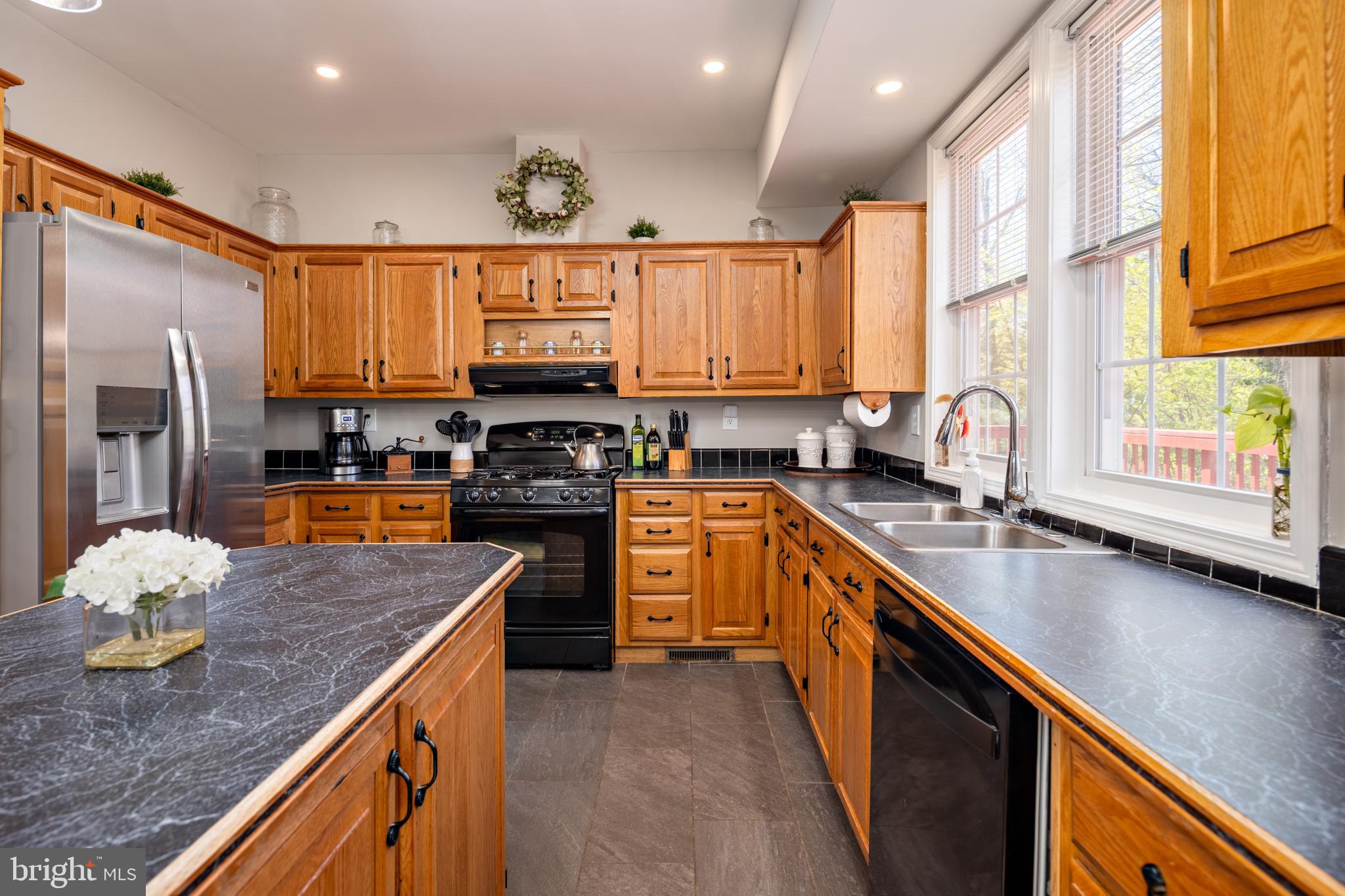 7213 Waterloo Pass Elkridge, MD 21075 - Photo 49 of 60 a kitchen with stainless steel appliances granite countertop a sink a stove and a refrigerator