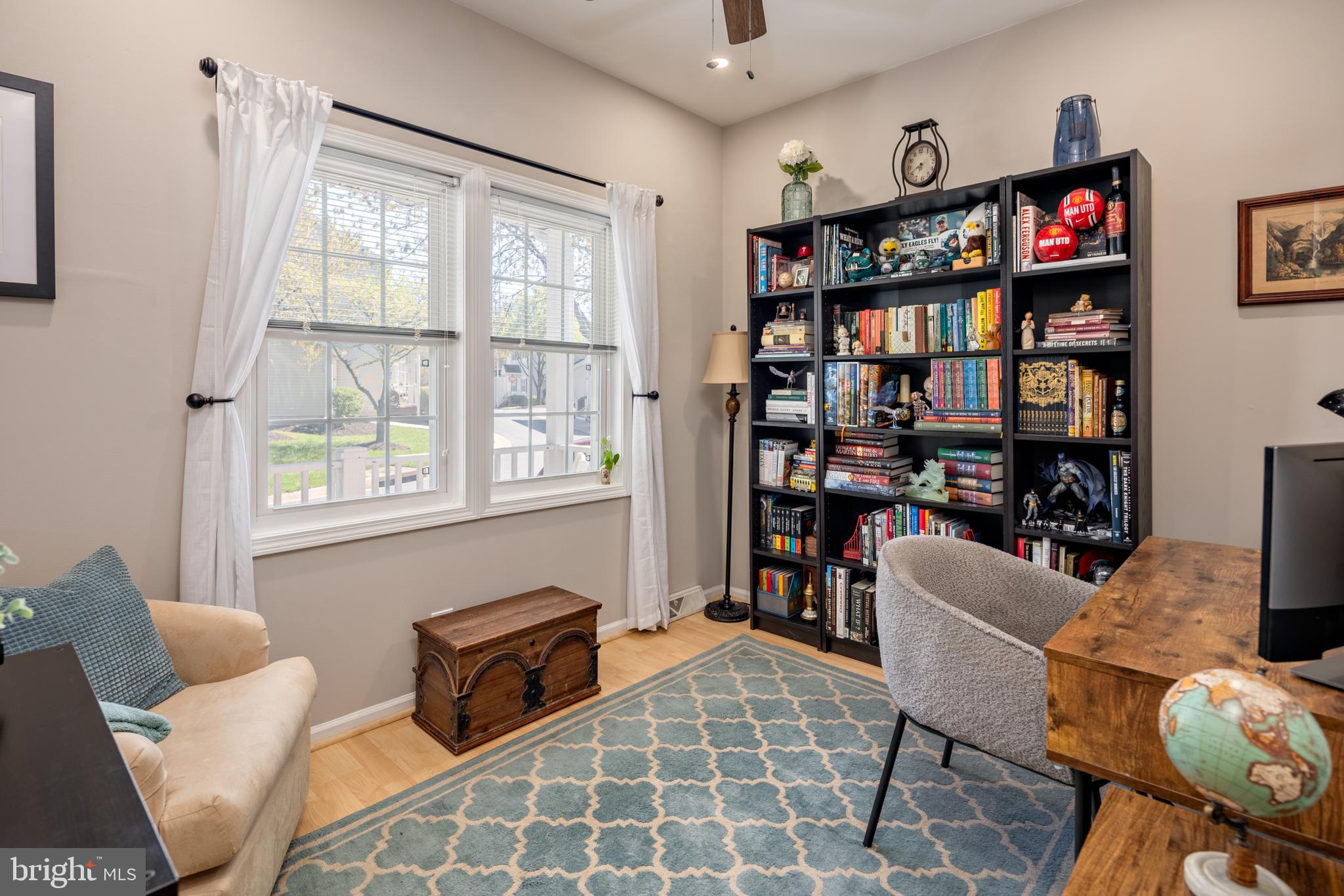 7213 Waterloo Pass Elkridge, MD 21075 - Photo 6 of 60 a living room with furniture a bookshelf and a window
