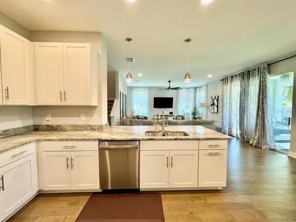 a kitchen with a sink stove and cabinets