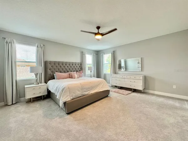 a spacious bedroom with a bed and a window