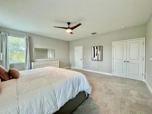 a bedroom with a large bed and a window