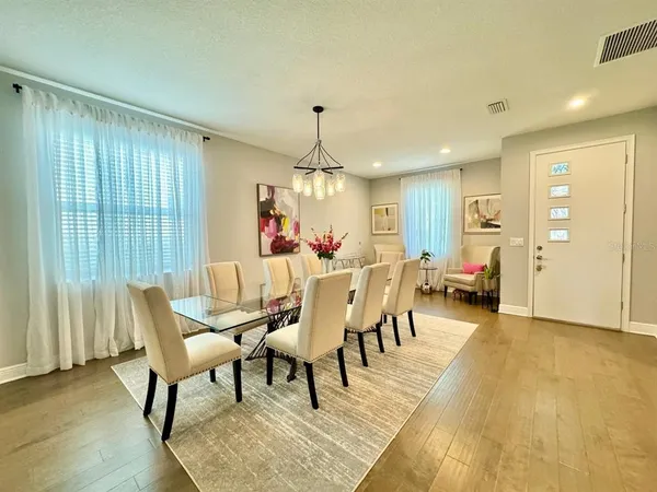 a dining room with furniture window and wooden floor