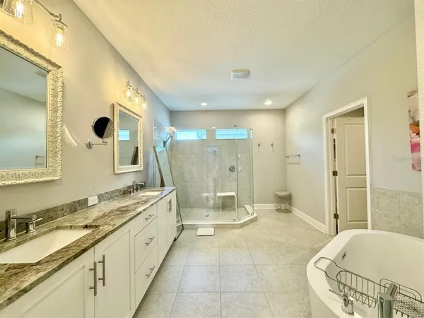 a bathroom with a granite countertop sink a toilet and shower