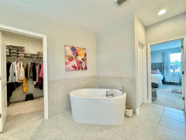 a view of a bathroom with a tub and shower