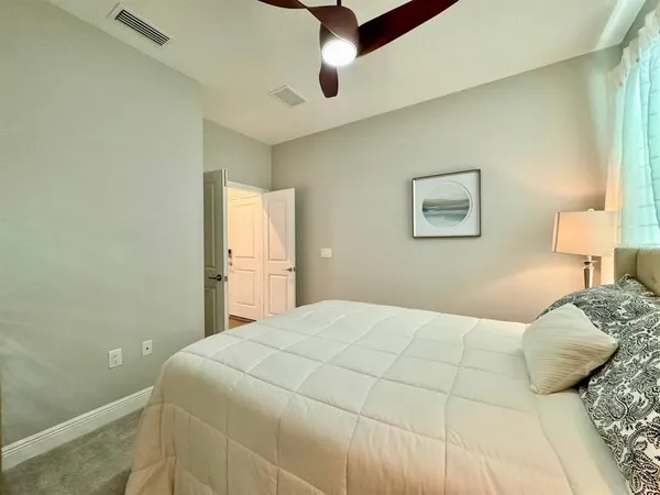 a bedroom with a bed and a painting on the wall
