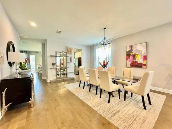 a living room with furniture a rug and white walls